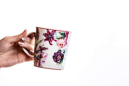 Woman hand holding a cup isolated on white background.の写真素材