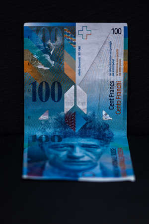 Selective focus on detail of 100 swiss franc banknote. Close up macro detail of money banknotes, swiss franc isolated. World money concept, inflation and economy conceptの写真素材