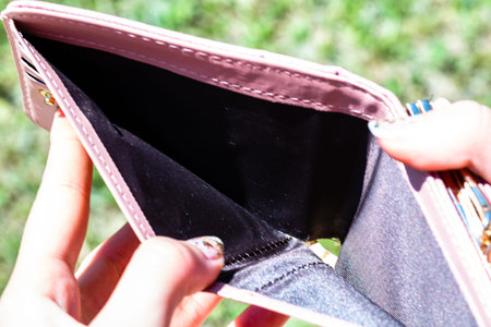 Hands holding and showing an empty wallet. Lack of money,  need of money low income because of...