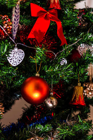 Christmas hanging decorations on fir tree. Decorated Christmas tree. Fir branch with Christmas baubles decorations.の写真素材