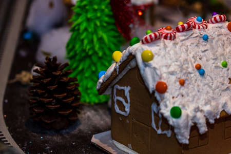 Colorful gingerbread house isolated on blurred background with Christmas decoration.の写真素材