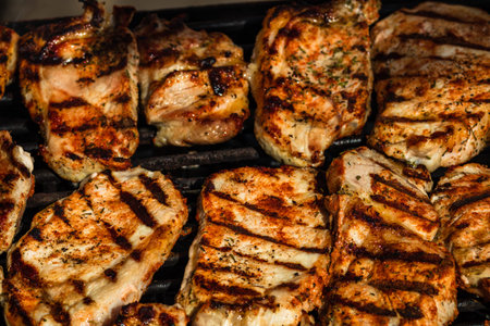 Grilling pork steaks. Delicious meat steaks close up cooking on the barbecue grill