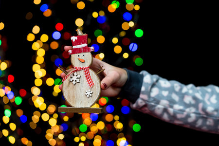 Woman's hands hold christmas decoration. Christmas and New Year holidays background, winter season...