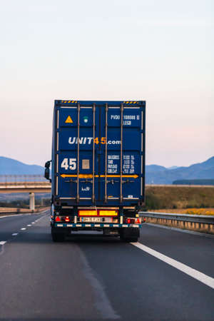 Back view of loaded European truck in motion on asphalt road, transportation and delivery concept. Bucharest, Romania, 2020のeditorial素材