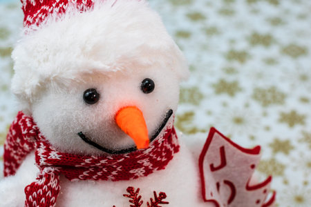 Snowman figurine isolated close up on details. Christmas composition with seasonal decorations and...