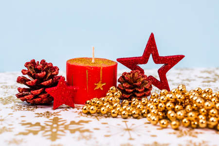 Close up of decorated christmas red candle isolated. Christmas composition with seasonal decorations and ornaments, colorful christmas background christmassy mood concept.の写真素材