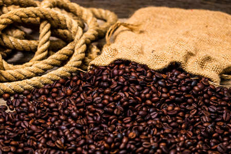 Roasted coffee beans isolated on wooden table.の写真素材