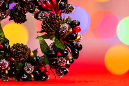 Colorful decorated Christmas wreaths isolated on background of blurred lights.の写真素材