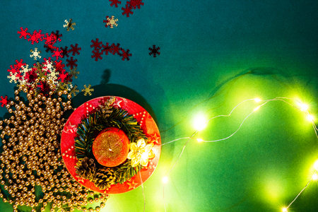Christmas lights over a december season composition with ornaments and decorations. Top view with...