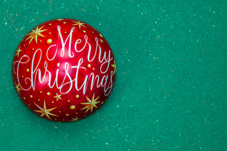December season composition, top view with copy space on green background. Christmas ball with Merry Christmas text.の写真素材