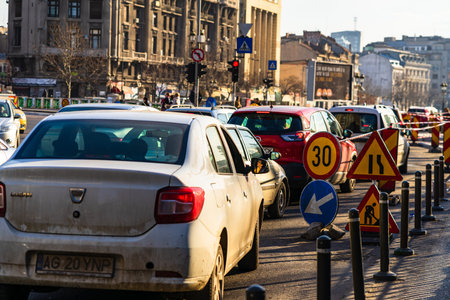 Car traffic at rush hour in downtown area of the city. Car pollution, traffic jam in the morning and...