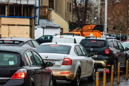 Car traffic at rush hour in downtown area of the city during a rainy day. Car pollution, traffic jam in the capital city of Bucharest, Romania, 2020のeditorial素材