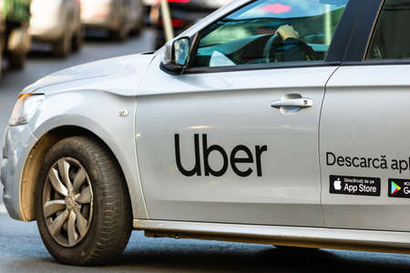 Uber car in traffic, modern city taxi service. Car pollution, traffic jam in the morning and evening in the capital city of Bucharest, Romania, 2020のeditorial素材