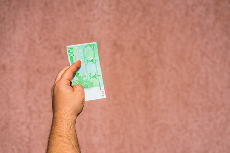 Hand holding and showing euro money or giving money. World money concept, 100 EURO banknotes EUR currency isolated. Concept of rich business people, saving or spending money.の写真素材