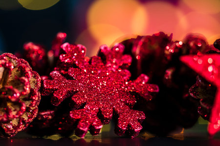 Decorations and ornaments in a colorful Christmas composition isolated on background of blurred...