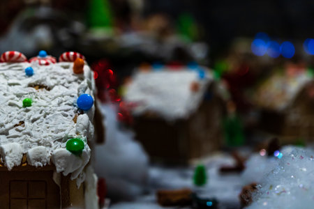 Colorful gingerbread house isolated on blurred background with Christmas decoration.の写真素材