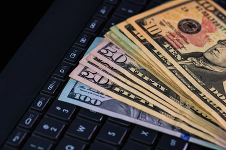 Close up of dollars money on keyboard isolated.の写真素材