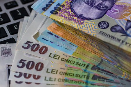 Lei banknotes on keyboard. Selective focus on stack of LEI romanian money.の写真素材