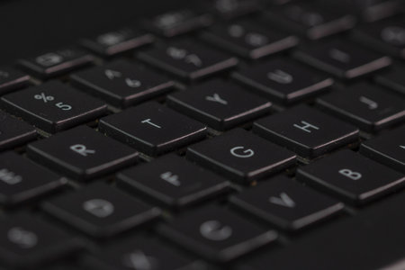 Selective focus, details of laptop keyboard. Remote work, business and office concept.の写真素材