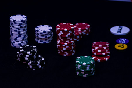 Stack of poker chips on black background