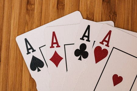 Playing cards aces card close up, isolated on wooden table. Casino concept, risk, chance, good luck or gambling.の写真素材