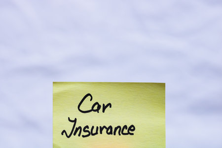 Car insurance handwriting text close up isolated on yellow paper with copy space.の写真素材