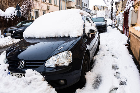 Snow on cars in the morning. Winter season, icy cars. Winter concept, frozen cars on the road in Bucharest, Romania, 2020のeditorial素材