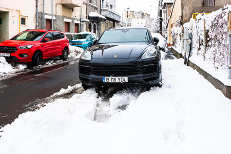 Snow on cars in the morning. Winter season, icy cars. Winter concept, frozen cars on the road in Bucharest, Romania, 2020のeditorial素材