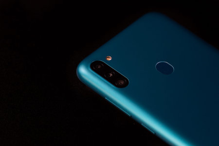 Selective focus on back of new smartphone Samsung Galaxy M11 triple camera and fingerprint sensor....