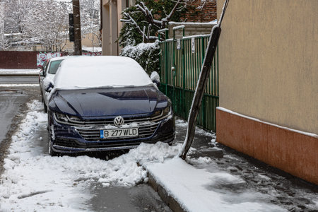 Snow on cars in the morning. Winter season, icy cars. Winter concept, frozen cars on the road in Bucharest, Romania, 2021のeditorial素材