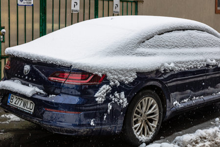 Snow on cars in the morning. Winter season, icy cars. Winter concept, frozen cars on the road in...