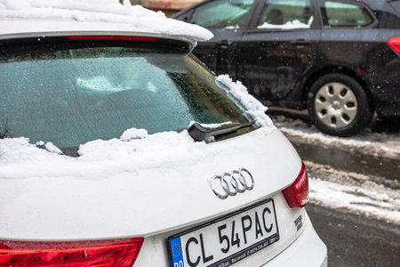 Snow on cars in the morning. Winter season, icy cars. Winter concept, frozen cars on the road in Bucharest, Romania, 2021のeditorial素材