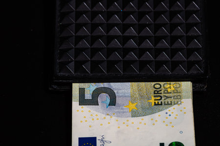 5 Euro money banknotes in black wallet isolatedの写真素材