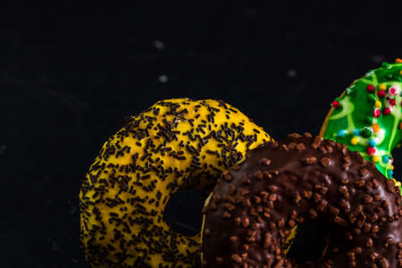 Glazed donuts with sprinkles isolated. Close up of colorful donuts.の写真素材