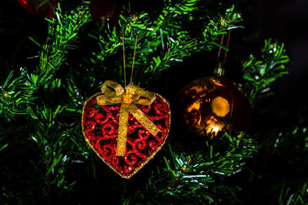 Christmas hanging decorations on fir tree. Decorated Christmas tree. Fir branch with Christmas baubles decorations.の写真素材