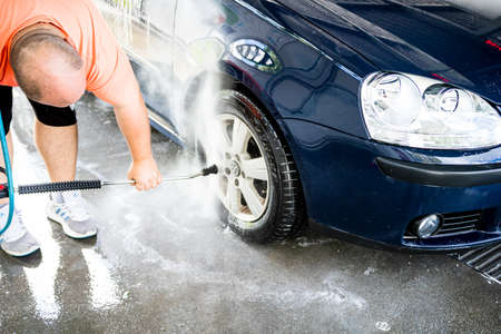 Washing and cleaning car in self service car wash station. Car washing using high pressure water in Bucharest, Romania, 2021のeditorial素材
