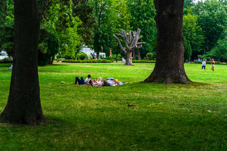 People having picnic relaxing and having fun during coronavirus crisis in park and gardens of the domain from Mogosoaia in Bucharest, Romania, 2020.のeditorial素材
