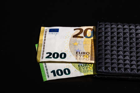 100 euro and 200 euro banknotes in black wallet isolatedの写真素材