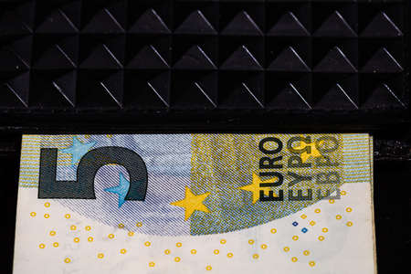 5 Euro money banknotes in black wallet isolatedの写真素材