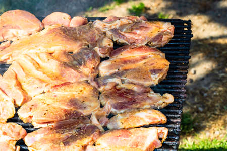 Raw steak on a charcoal barbeque. Top view of camping tasty barbecue, food concept, food on grill and detail of food on the grillの写真素材