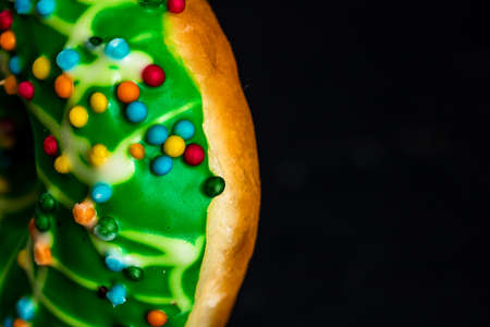 Green glazed donut with sprinkles isolated. Close up of colorful donut.の写真素材