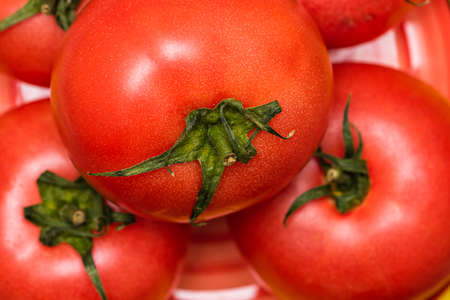 Close up of ripe red tomato, tomatoes background.の写真素材