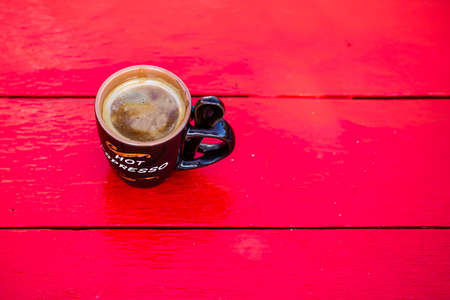 Cup of fresh made coffee on wooden backgroundの写真素材
