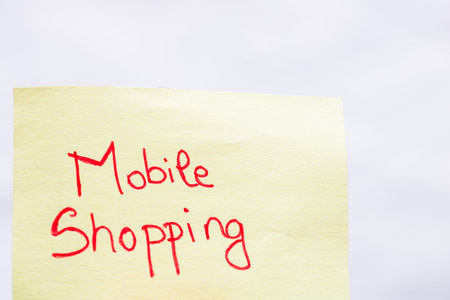 Mobile shopping handwriting text close up isolated on yellow paper with copy space.