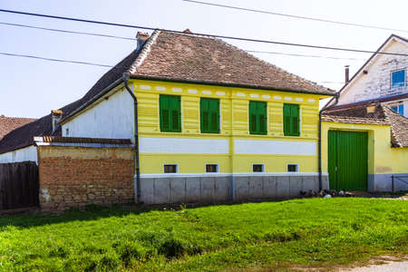 Typical rural landscape and rustic houses in Barcut -Bekokten, Transylvania, Romania, 2021.のeditorial素材