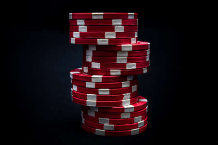 Stack of poker chips on black backgroundの写真素材