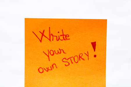 Write your own story handwriting text close up isolated on yellow paper with copy space.の写真素材