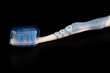 Selective focus on toothbrush isolated on black background.の写真素材