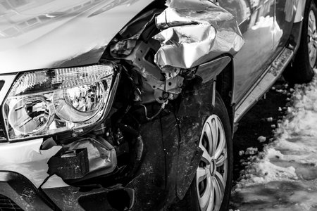 Damaged car detail on crushed car, wrecked vehicle. Crushed metal and plastic after a traffic accident in Bucharest, Romania, 2021のeditorial素材
