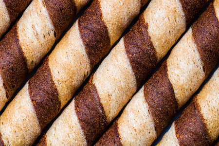 Macro selective focus on chocolate wafer rolls. Chocolate sticks backgroundの写真素材